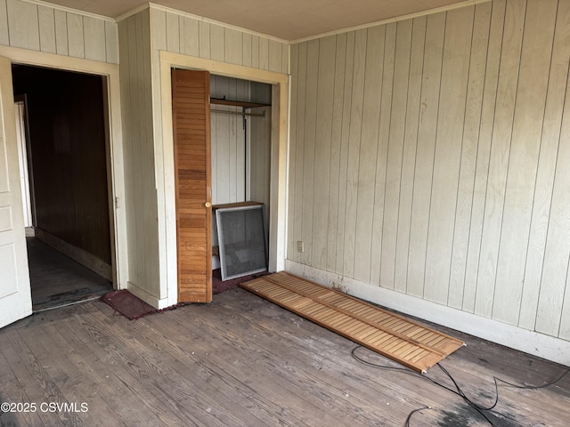 615 Broad St, Berwick, PA 18603 - unfurnished bedroom with wood walls, ornamental molding, wood finished floors, and a closet