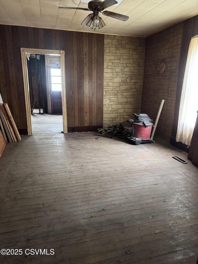 615 Broad St, Berwick, PA 18603 - spare room featuring a ceiling fan, wood walls, and hardwood / wood-style flooring