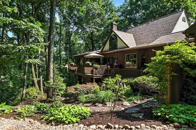 68 March Cir, Winfield, PA 17889 - view of side of home with a shingled roof, a chimney, and a wooden deck