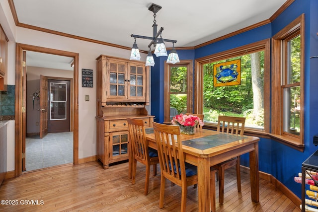 68 March Cir, Winfield, PA 17889 - dining area featuring plenty of natural light, light wood-style flooring, crown molding, and a chandelier