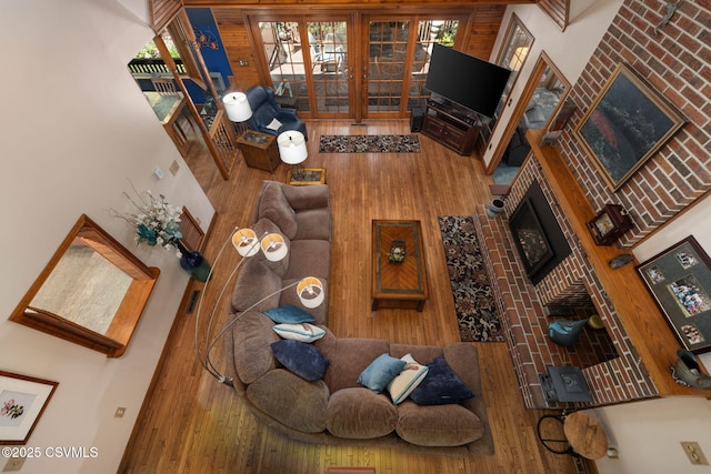 68 March Cir, Winfield, PA 17889 - living area with wood finished floors and a brick fireplace