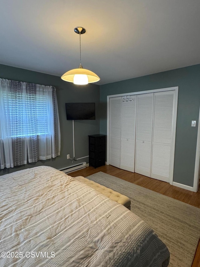 150 Blue Spruce Ln, Shamokin, PA 17872 - bedroom featuring wood finished floors, a baseboard heating unit, and a closet