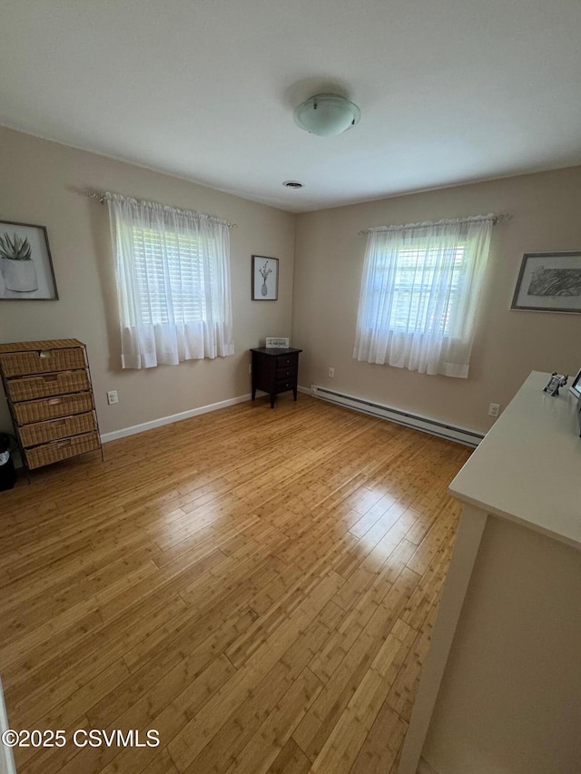 150 Blue Spruce Ln, Shamokin, PA 17872 - unfurnished bedroom featuring a baseboard radiator and light wood-style floors