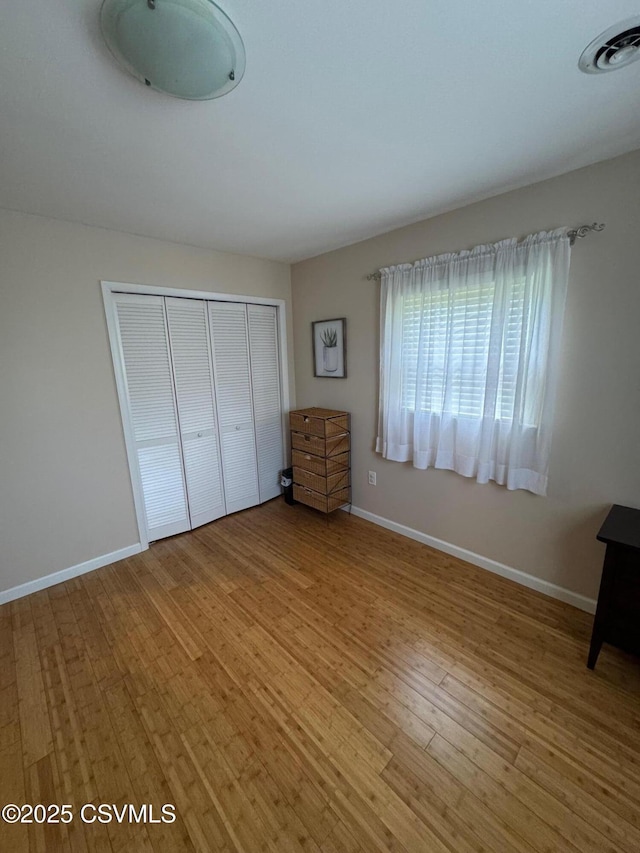 150 Blue Spruce Ln, Shamokin, PA 17872 - unfurnished bedroom featuring wood finished floors and a closet