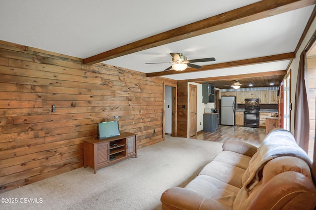 4792 Muncy Exchange Rd, Turbotville, PA 17772 - living area with wood walls, beamed ceiling, light colored carpet, and a ceiling fan