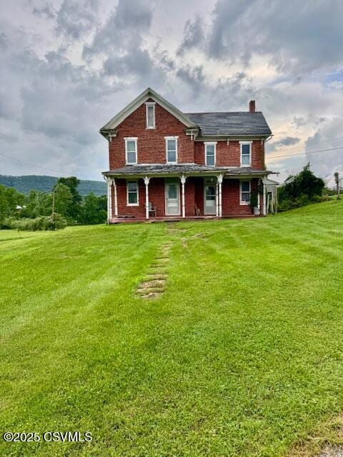 352 Turkey Hill Rd, Elysburg, PA 17824 - view of front of house with a chimney, a front yard, and brick siding