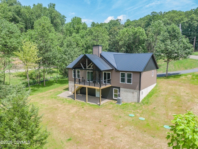 352 Turkey Hill Rd, Elysburg, PA 17824 - back of property with a chimney, a yard, a wooden deck, and a metal roof
