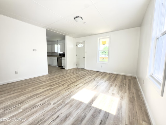 1613 2nd Ave, Berwick, PA 18603 - unfurnished living room with light wood-style floors and baseboards