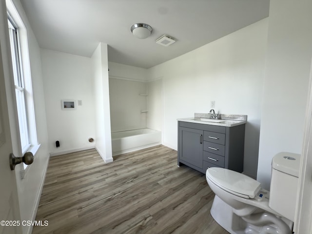 1613 2nd Ave, Berwick, PA 18603 - full bath featuring wood finished floors, vanity, and washtub / shower combination
