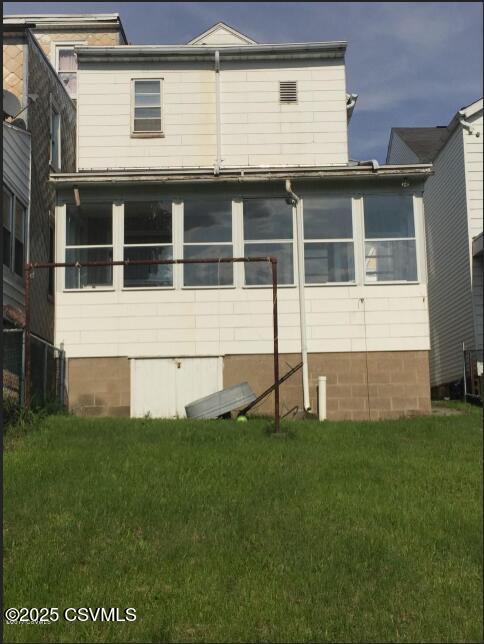 214 N Vine St, Shamokin, PA 17872 - rear view of house with a lawn
