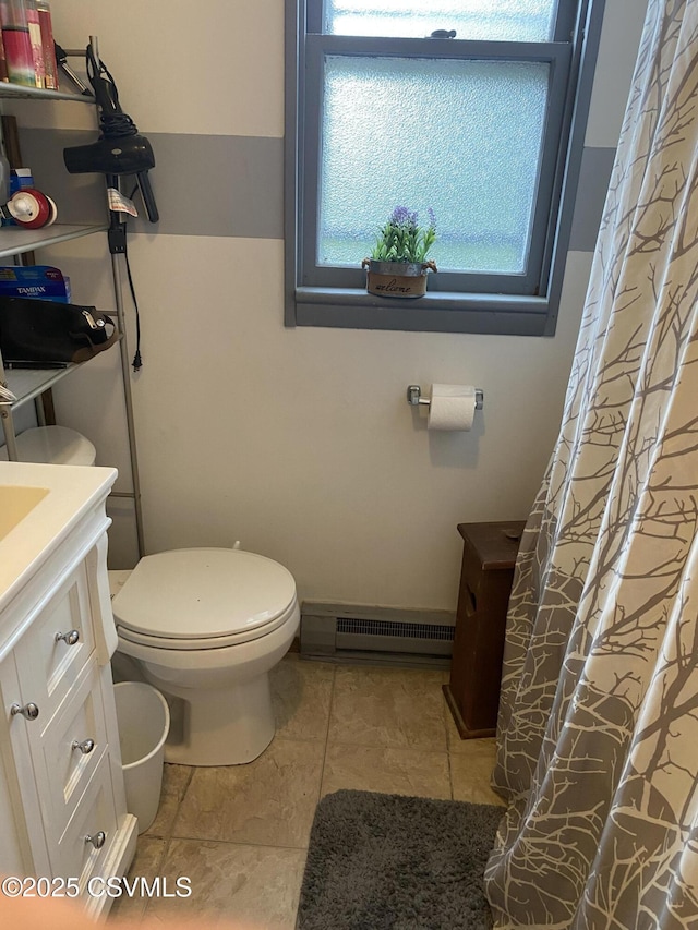 214 N Vine St, Shamokin, PA 17872 - bathroom with baseboard heating, vanity, tile patterned floors, and curtained shower