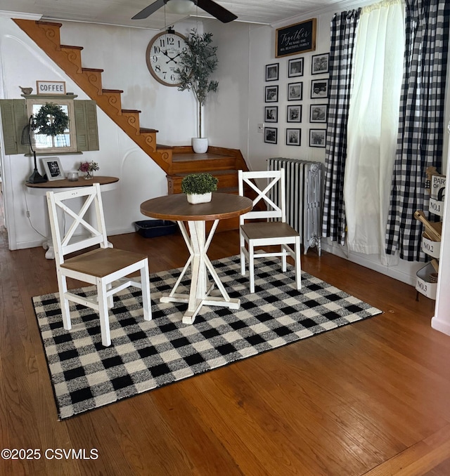 223 N Vine St, Shamokin, PA 17872 - dining area with radiator heating unit, wood finished floors, stairway, and a ceiling fan