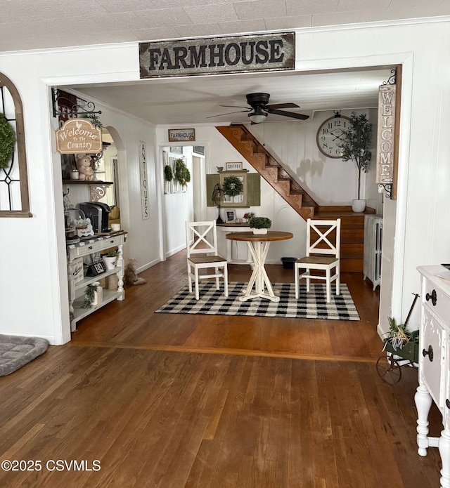 223 N Vine St, Shamokin, PA 17872 - dining area featuring radiator, a ceiling fan, wood finished floors, arched walkways, and stairway