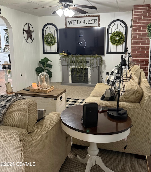 223 N Vine St, Shamokin, PA 17872 - living room featuring a ceiling fan, arched walkways, and a fireplace