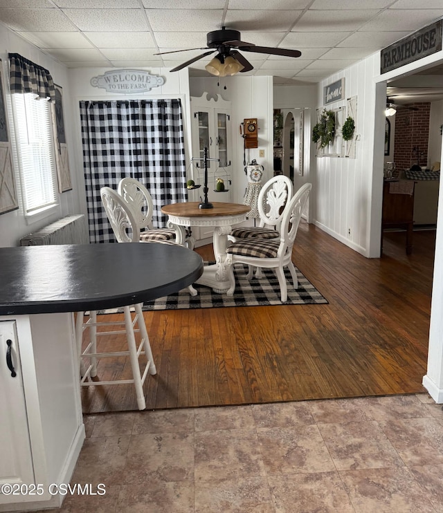 223 N Vine St, Shamokin, PA 17872 - dining room featuring a ceiling fan, a drop ceiling, and radiator