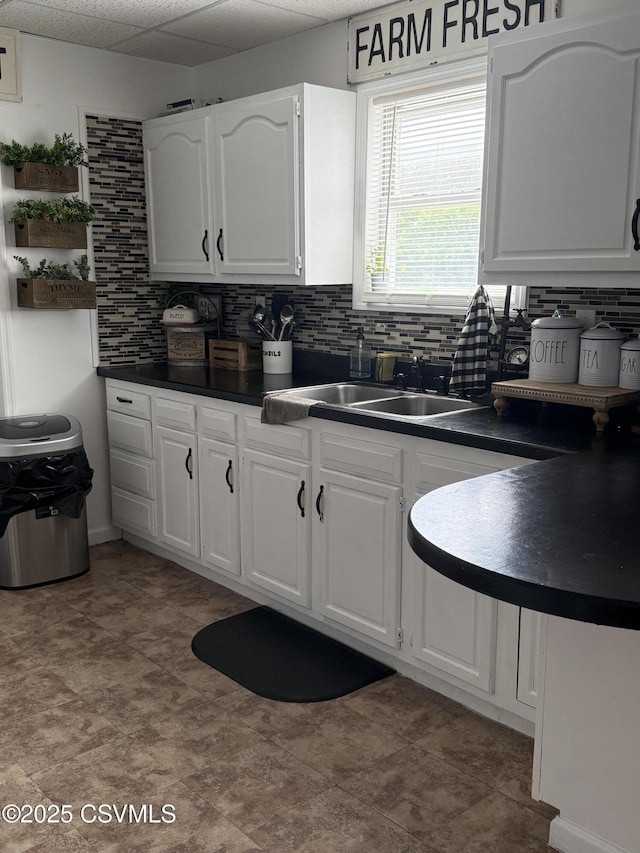 223 N Vine St, Shamokin, PA 17872 - kitchen with dark countertops, decorative backsplash, and white cabinets