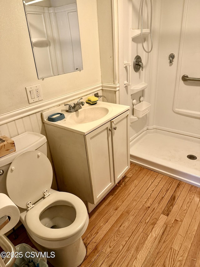 1507 Fairview Ave, Berwick, PA 18603 - bathroom featuring a stall shower, a wainscoted wall, wood finished floors, and vanity