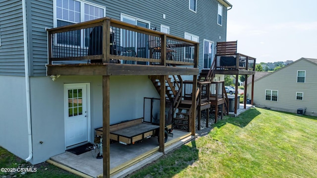 5 Williamsburg Blvd, Bloomsburg, PA 17815 - rear view of property featuring a wooden deck, a lawn, stairway, and a patio area