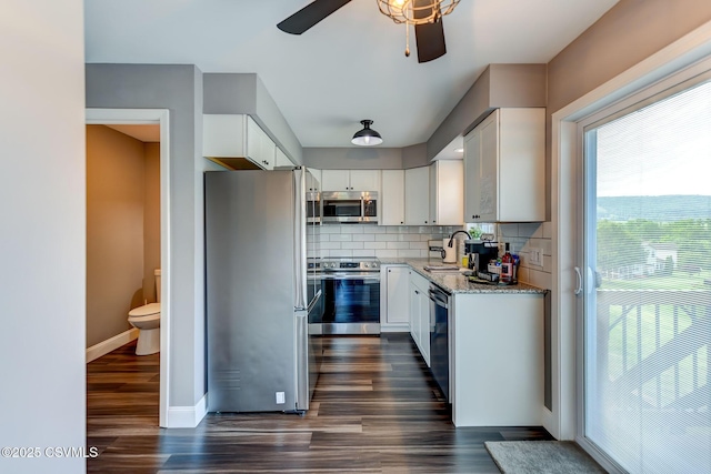5 Williamsburg Blvd, Bloomsburg, PA 17815 - kitchen featuring appliances with stainless steel finishes, dark wood-style floors, light stone countertops, ceiling fan, and white cabinetry