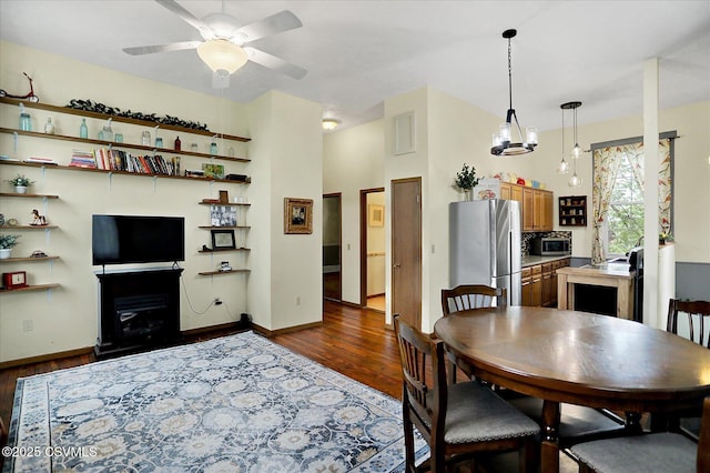 12 State School Rd, Selinsgrove, PA 17870 - dining area featuring dark wood-type flooring, ceiling fan, and a glass covered fireplace