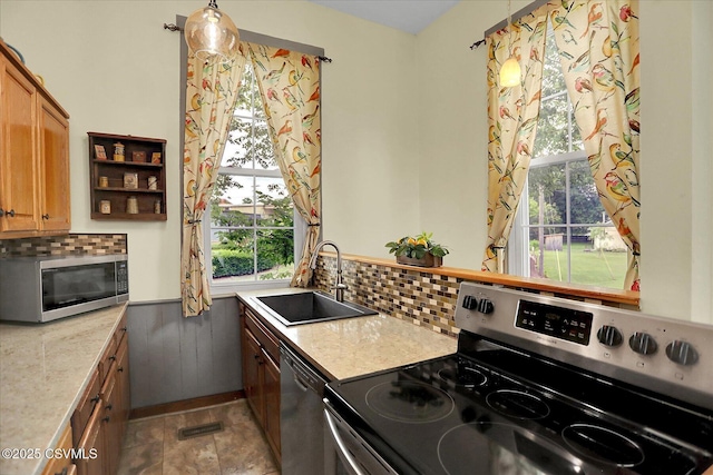 12 State School Rd, Selinsgrove, PA 17870 - kitchen with appliances with stainless steel finishes, light countertops, backsplash, and healthy amount of natural light