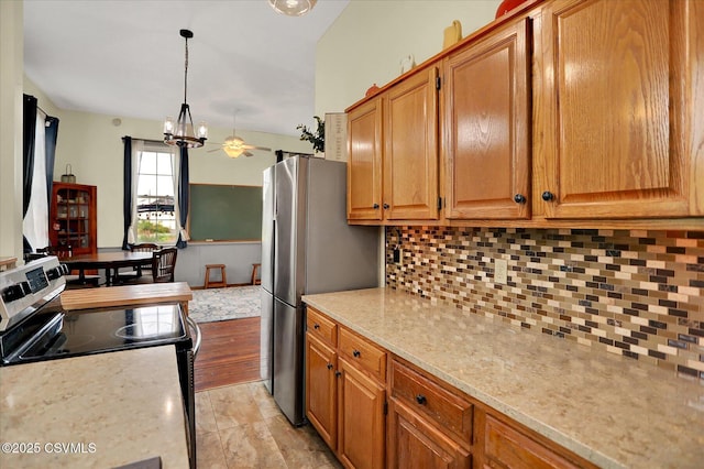 12 State School Rd, Selinsgrove, PA 17870 - kitchen featuring stainless steel appliances, tasteful backsplash, a chandelier, hanging light fixtures, and brown cabinetry