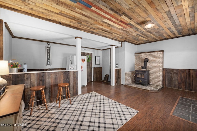 178 Schooners Run, Shickshinny, PA 18655 - indoor bar featuring freestanding refrigerator, a wood stove, wood finished floors, a wainscoted wall, and ornamental molding
