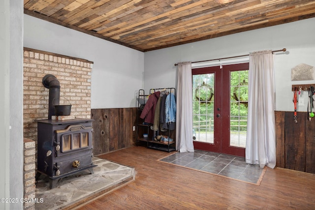 178 Schooners Run, Shickshinny, PA 18655 - foyer entrance featuring french doors, a wainscoted wall, healthy amount of natural light, wood finished floors, and a wood stove