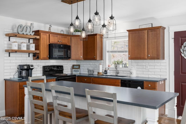 178 Schooners Run, Shickshinny, PA 18655 - kitchen featuring black appliances, dark countertops, decorative backsplash, and brown cabinetry