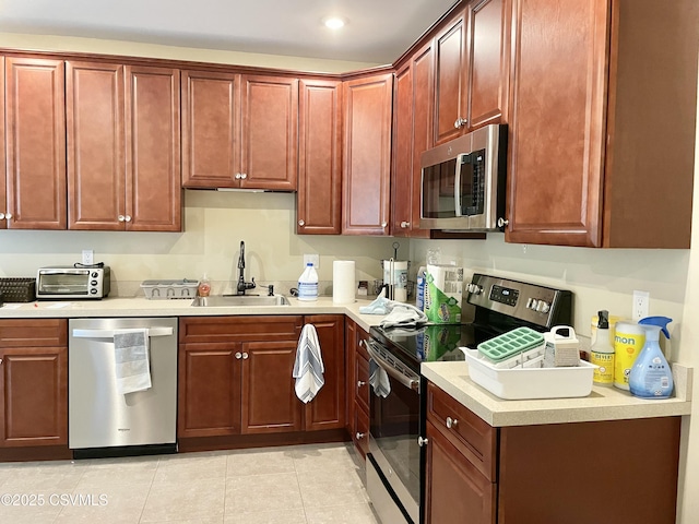 130-132 S 5th St, Lewisburg, PA 17837 - kitchen with stainless steel appliances, light countertops, light tile patterned floors, recessed lighting, and reddish brown cabinets