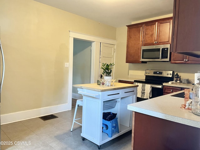 130-132 S 5th St, Lewisburg, PA 17837 - kitchen with appliances with stainless steel finishes, light countertops, and a breakfast bar