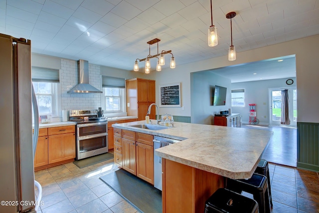 4429 Rte 204, Selinsgrove, PA 17870 - kitchen featuring stainless steel appliances, wall chimney range hood, light countertops, open floor plan, and decorative light fixtures