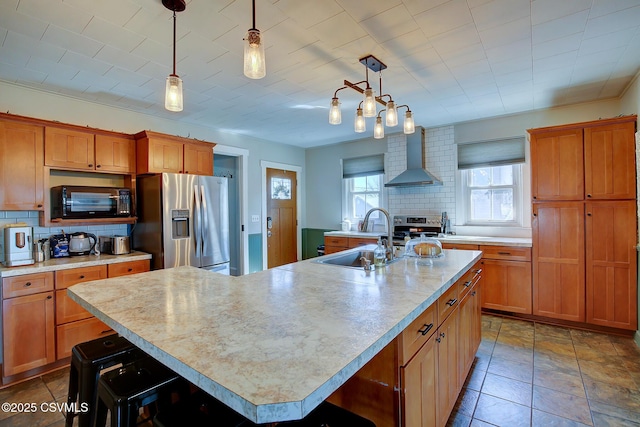 4429 Rte 204, Selinsgrove, PA 17870 - kitchen with appliances with stainless steel finishes, wall chimney range hood, light countertops, decorative backsplash, and a large island with sink