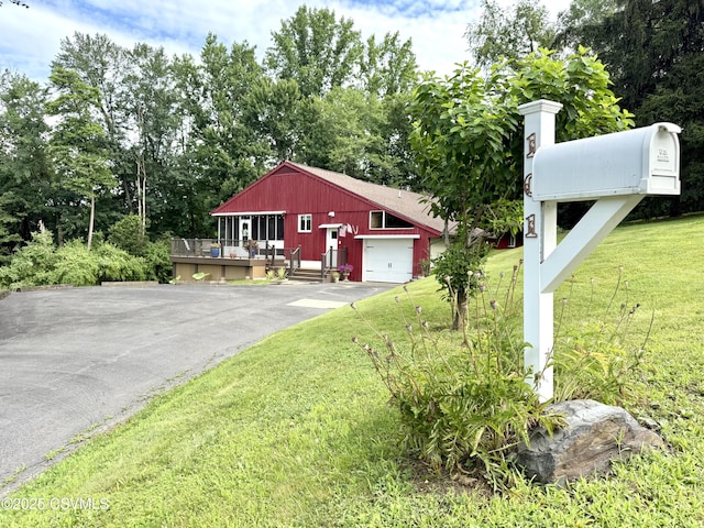 101 Twig Ln, Sunbury, PA 17801 - view of front of home featuring asphalt driveway, a front lawn, a deck, and view of scattered trees