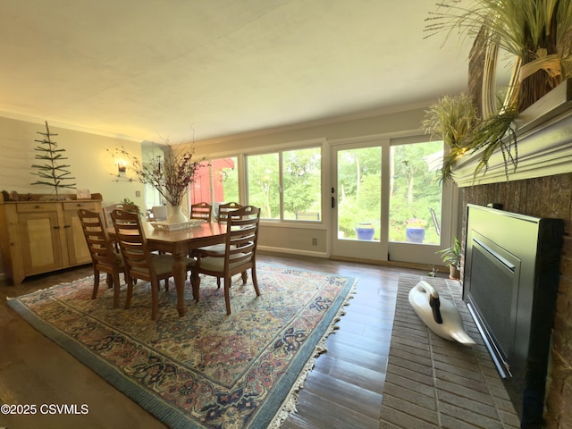 101 Twig Ln, Sunbury, PA 17801 - dining space with crown molding, a glass covered fireplace, and wood finished floors