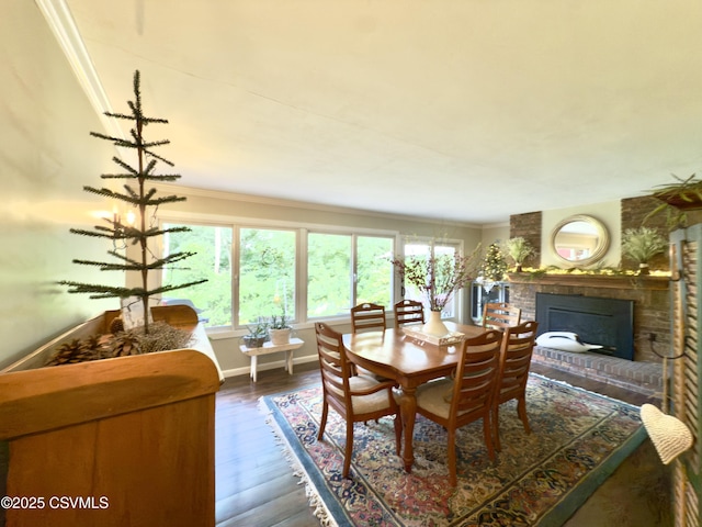 101 Twig Ln, Sunbury, PA 17801 - dining room featuring crown molding, a brick fireplace, and dark wood finished floors
