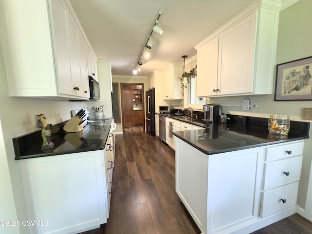 101 Twig Ln, Sunbury, PA 17801 - kitchen featuring black appliances, dark countertops, a peninsula, white cabinetry, and dark wood finished floors