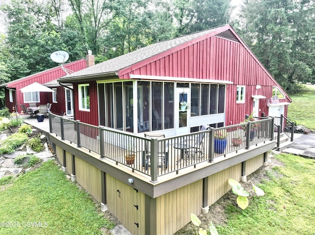 101 Twig Ln, Sunbury, PA 17801 - rear view of property with a deck, a shingled roof, a sunroom, outdoor dining space, and a chimney