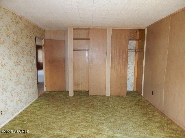 404 W Center St, Elysburg, PA 17824 - unfurnished bedroom featuring wallpapered walls, two closets, and carpet flooring