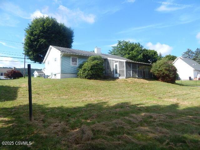 404 W Center St, Elysburg, PA 17824 - view of grassy yard with a sunroom