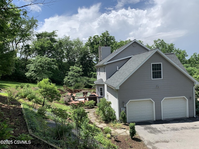 3 Walnut Rd, Lewisburg, PA 17837 - view of property exterior featuring a chimney, a shingled roof, an attached garage, driveway, and a deck