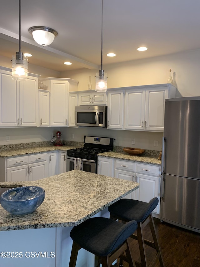 3 Walnut Rd, Lewisburg, PA 17837 - kitchen featuring stainless steel appliances, white cabinets, recessed lighting, hanging light fixtures, and a kitchen bar