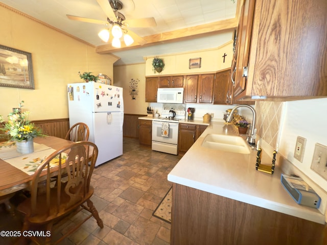230 S 6th St, Shamokin, PA 17872 - kitchen with white appliances, stone tile floors, light countertops, ceiling fan, and a wainscoted wall
