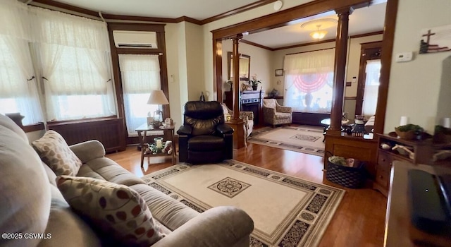 230 S 6th St, Shamokin, PA 17872 - living area with ornate columns, a wall unit AC, wood finished floors, and ornamental molding