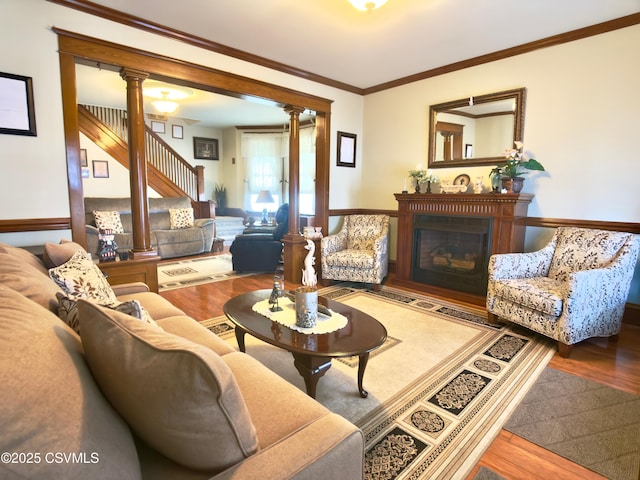 230 S 6th St, Shamokin, PA 17872 - living room with a glass covered fireplace, wood finished floors, ornate columns, crown molding, and stairway