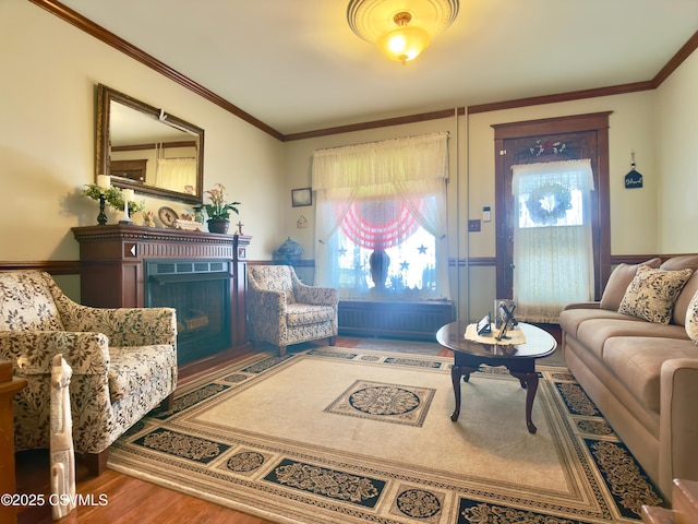 230 S 6th St, Shamokin, PA 17872 - living area featuring a fireplace, wainscoting, wood finished floors, and ornamental molding