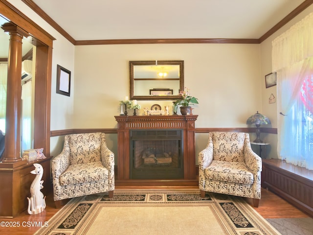 230 S 6th St, Shamokin, PA 17872 - sitting room featuring wood finished floors, ornamental molding, a fireplace, and ornate columns