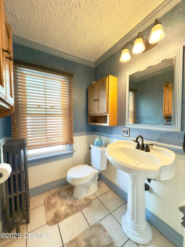 230 S 6th St, Shamokin, PA 17872 - half bathroom featuring a textured ceiling, radiator heating unit, tile patterned floors, ornamental molding, and a wainscoted wall