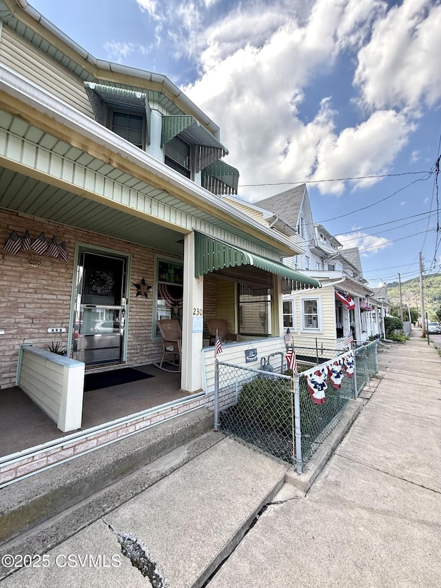 230 S 6th St, Shamokin, PA 17872 - view of side of home featuring a porch and brick siding