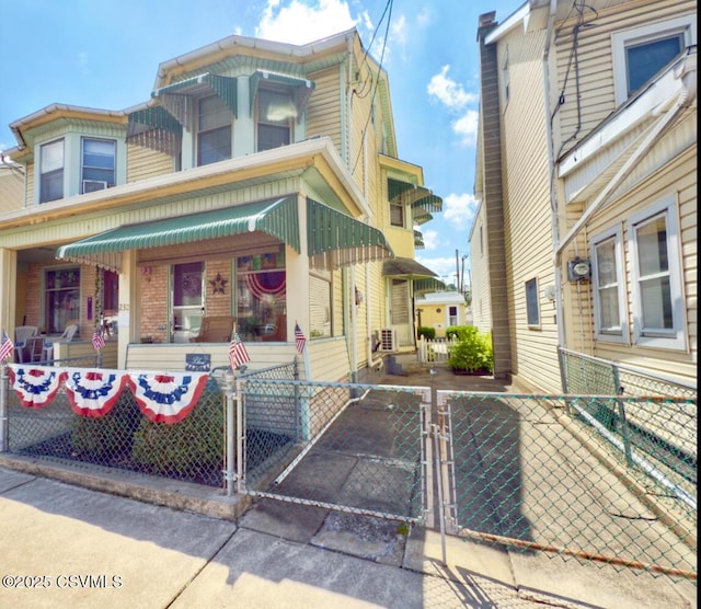 230 S 6th St, Shamokin, PA 17872 - view of front of property with a gate, a fenced front yard, and a porch
